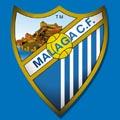 малага